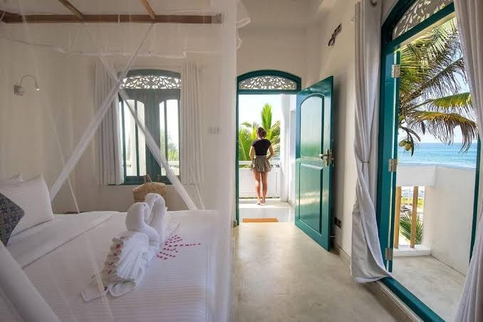 Lighthouse bedroom with a door open to the sea